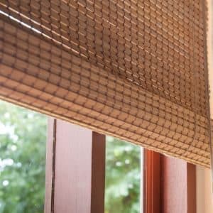 Rattan blinds add an organic, textured look to window treatments in a seaside setting.