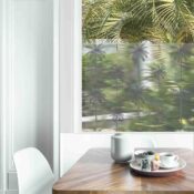 Dining table with fresh flowers and breakfast tray with coffee c