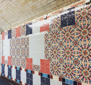 Tile decals or privacy window film on a wall can enhance any space just as brightly colored tiles do in a subway shown here.